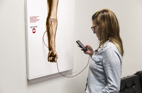 O banner interativo incentiva a doação de sangue e carrega a bateria do celular ao mesmo tempo.