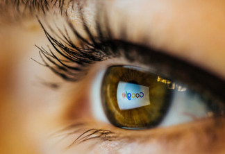 Bucharest, Romania – June 18,2016 : Blurry closeup of a wet brown eye with google’s logo reflected on it. Illustrative editorial taken from right side.